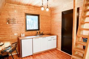 ein Bad mit einem Waschbecken und einem Fenster in der Unterkunft Cozy chalet in Mestia in Mestia