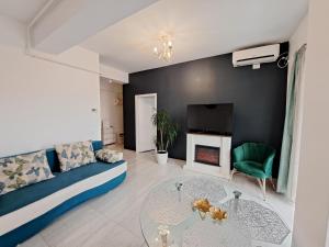 a living room with a couch and a fireplace at Highsky Oradea Apartments in Oradea