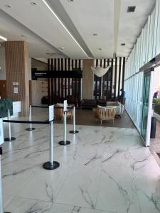 a lobby with marble floors and a lobby with chairs at SALINAS PARK RESORT in Salinópolis
