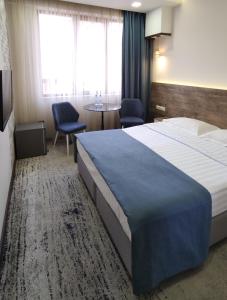 a hotel room with a large bed and a table at EVN Boutique Hotel in Yerevan