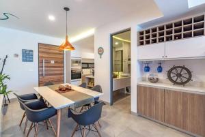 a kitchen and dining room with a table and chairs at Tolok condo at Icono Playa in Playa del Carmen