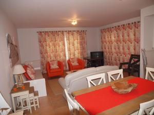 - un salon avec un canapé, une table et des chaises dans l'établissement Real Village Praia Verde 142, à Praia Verde