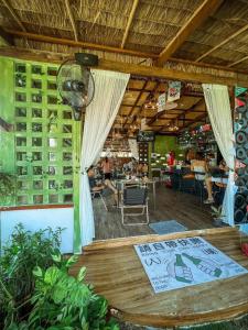 a restaurant with a table and chairs in a room at GO GLAMPING MAEPIM CAPE in Ban Nam Lai Ta Tum