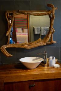 a bathroom with a bowl sink and a mirror at Ckoi Atacama Lodge in San Pedro de Atacama