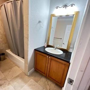 a bathroom with a sink and a mirror at Resort Like house, 4 bedrooms, 3 bathrooms in Orlando +47 photos