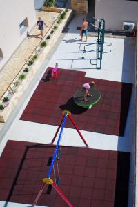 a group of people playing a game on a floor at Apartments Julijana 2 in Privlaka