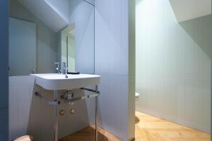 a bathroom with a sink and a mirror at The Palace Penthouse in Porto