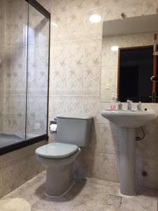 a bathroom with a toilet and a sink at Tu experiencia comienza aquí Departamento 3D 3C Achumani a pasos de la calle 29 in La Paz