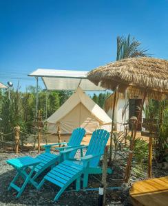 a group of blue chairs and a tent at GO GLAMPING MAEPIM CAPE in Ban Nam Lai Ta Tum