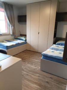 a room with two beds and cabinets in it at Apartma Vič Ljubljana in Ljubljana