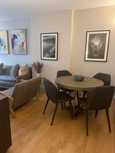 a living room with a table and chairs and a couch at 2 Bedroom Apartment just off Kings Road in London