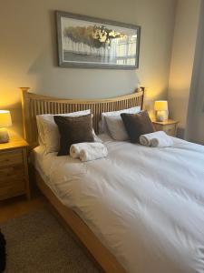 a large white bed with two pillows on it at 2 Bedroom Apartment just off Kings Road in London