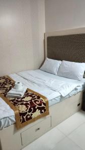 a bed with a tray with a towel on it at Birch Tower by Tristoff in Manila