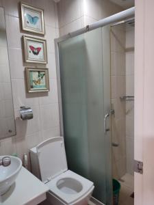 a bathroom with a shower and a toilet and a sink at Birch Tower by Tristoff in Manila