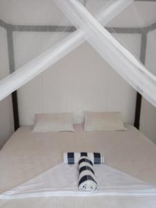 a bunk bed with a black and white pillow on it at Rock house in Hiriketiya