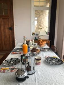 a table with food and orange juice on it at La Villa L'Escale - B&B vue mer à Audresselles in Audresselles +2 photos