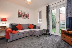 a living room with a couch and a tv at Victoria Gardens in Colchester +8 photos