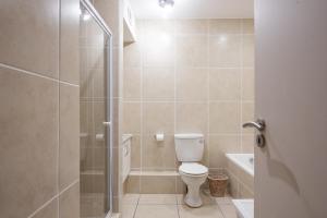 a bathroom with a toilet and a shower at INDIGO BAY 24 in Margate