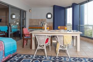 a dining room with a table and chairs at INDIGO BAY 24 in Margate