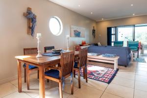 a living room with a table and a blue couch at INDIGO BAY 24 in Margate