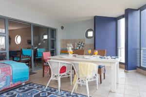 a dining room with a white table and chairs at INDIGO BAY 24 in Margate