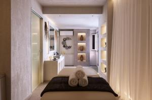 - une chambre avec un lit et des serviettes dans l'établissement Garifalakis Comfort Rooms, à Pollonia