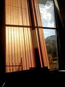 a window with a view of a building at Karbula Apartments & Villa in Mavrovo