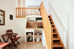 a staircase with wooden shelves in a room at Garifalakis House in Pollonia +8 photos