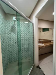 a glass shower in a bathroom with a sink at ALIZE CUMBUCO in Cumbuco