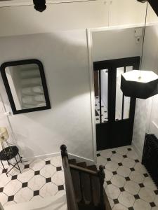 a bathroom with a sink and a mirror at La Maison de Louisette in Le Faouët