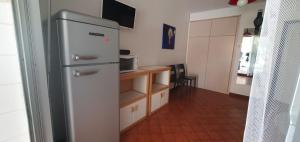 a small kitchen with a refrigerator and a counter at Nice studio with terrace near the sea in Saint-Mandrier-sur-Mer
