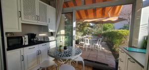 a kitchen with a table and chairs and a patio at Nice studio with terrace near the sea in Saint-Mandrier-sur-Mer