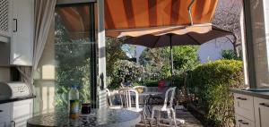 a table and chairs with an umbrella on a patio at Nice studio with terrace near the sea in Saint-Mandrier-sur-Mer