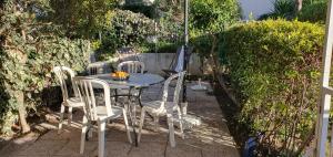 a table and chairs sitting on a patio at Nice studio with terrace near the sea in Saint-Mandrier-sur-Mer