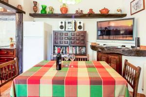 a dining room with a table and a television at Villa Fonto in Pollença