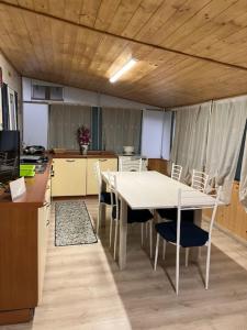 a kitchen with a table and chairs in a room at Villaggio Turistico Maderno in Toscolano Maderno