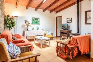 a living room with a couch and a tv at Villa Rosita in Pollença