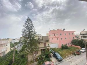 a city street with cars parked in front of buildings at Wabi Sabi house 2 in Ierápetra