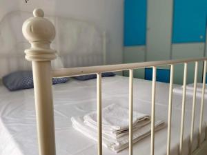 a bunk bed with a white crib with towels on it at Wabi Sabi house 2 in Ierápetra