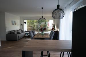 a living room with a table and a couch at Villa Emma in Osnabrück