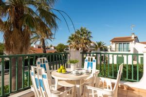 a table and chairs on the balcony of a house at Villa Elizabet in Cala en Forcat