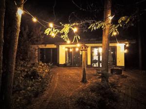 a house with lights in front of it at night at .... chillout między Łodzią a Warszawą in Nieborów