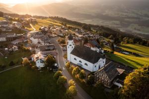 an aerial view of a small town with a church at Pension Hilde Ferienwohnung in Sulzberg