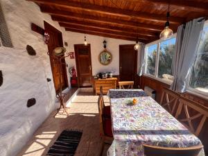 a dining room with a table and a table and a room with a tableablish at Fincasol in San Sebastián de la Gomera
