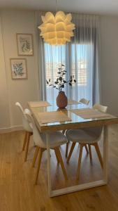 a dining room table and chairs with a vase on it at BAEZA GOLDEN in Baeza