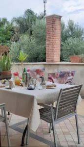 a white table and chairs on a patio at Il Tuffatore B&B in Capaccio-Paestum