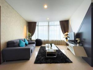 a living room with a couch and a tv at The Luxury Penthouses Kuala Lumpur in Kuala Lumpur