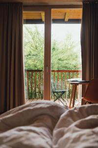 a bed in a bedroom with a view of a balcony at Pension Obertrum am See in Obertrum am See