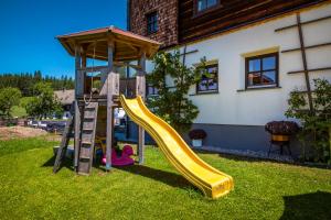 a playground with a slide in a yard at Chalet Schintlbauer in Annaberg im Lammertal