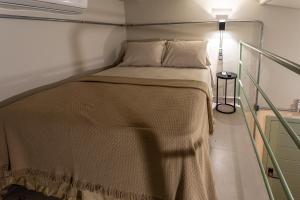 a bed in a small room with a lamp at Casa Savana in São Paulo
